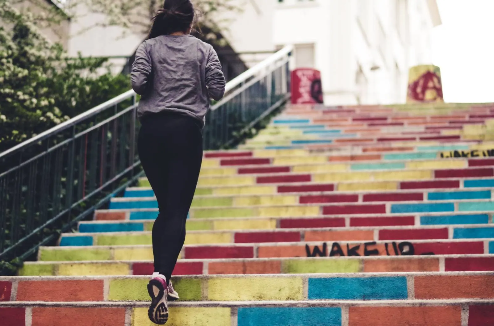 Woman running up the stairs - Top 7 Tips to Stay Active